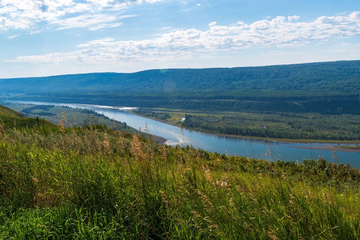 Scenic view of a river winding through hills and grasslands near Fort Saint John.