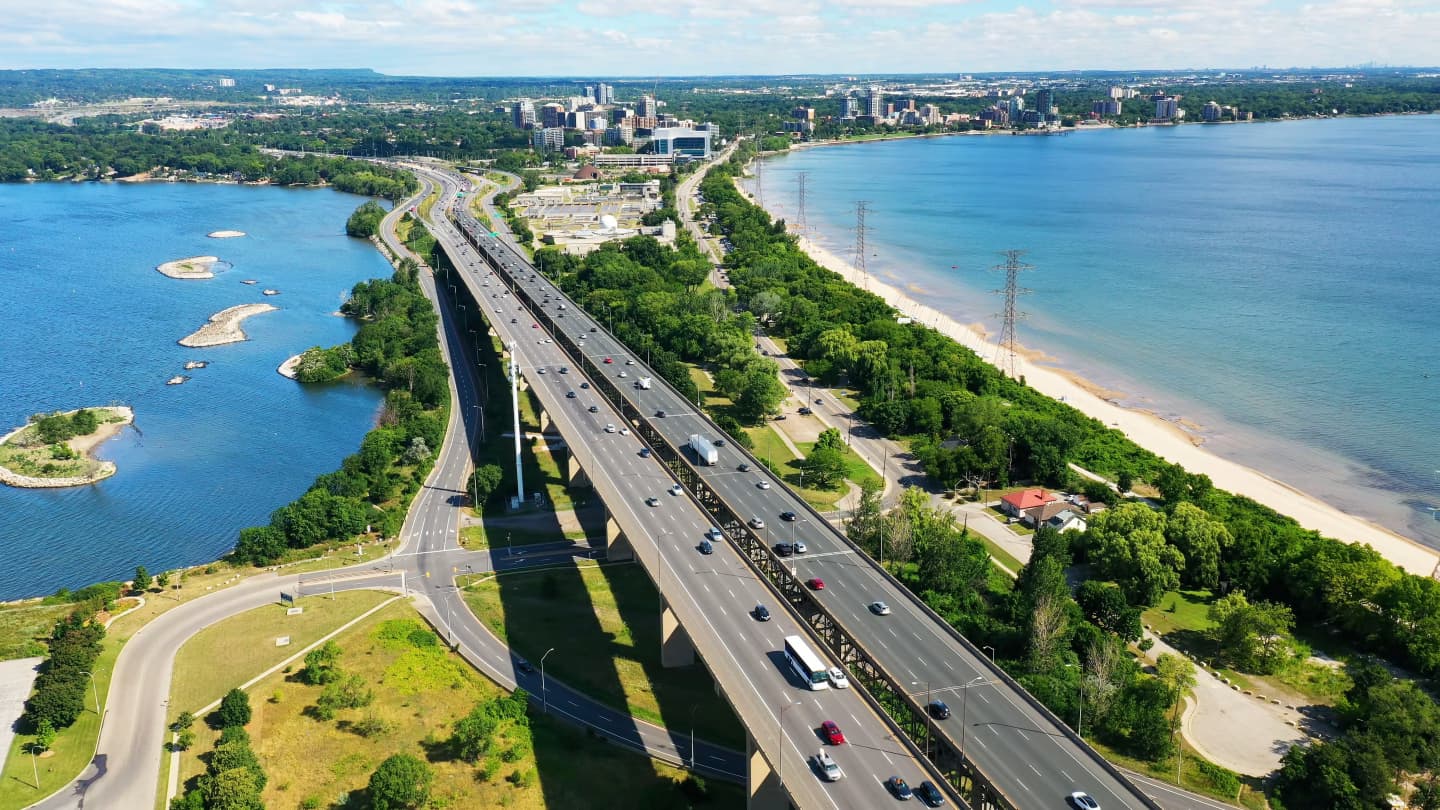 Aerial view of the Burlington Skyway bridge and surrounding area, with Lake Ontario and Burlington's waterfront.