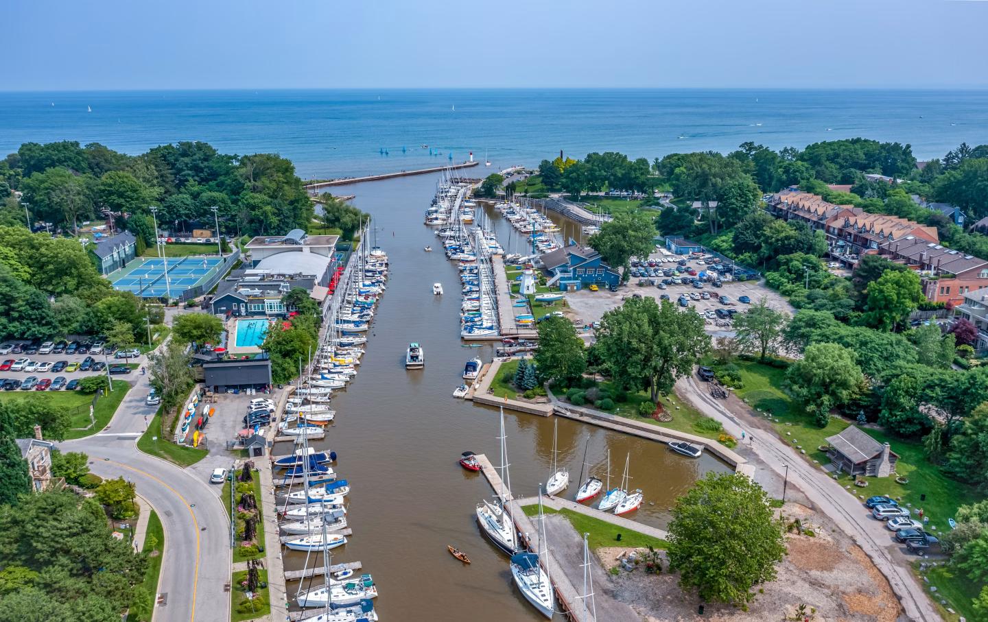 Aerial view of a marina near Oakville, with boats docked along a river leading to a lake.