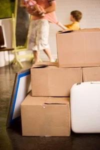 Stack of moving boxes with family in the background